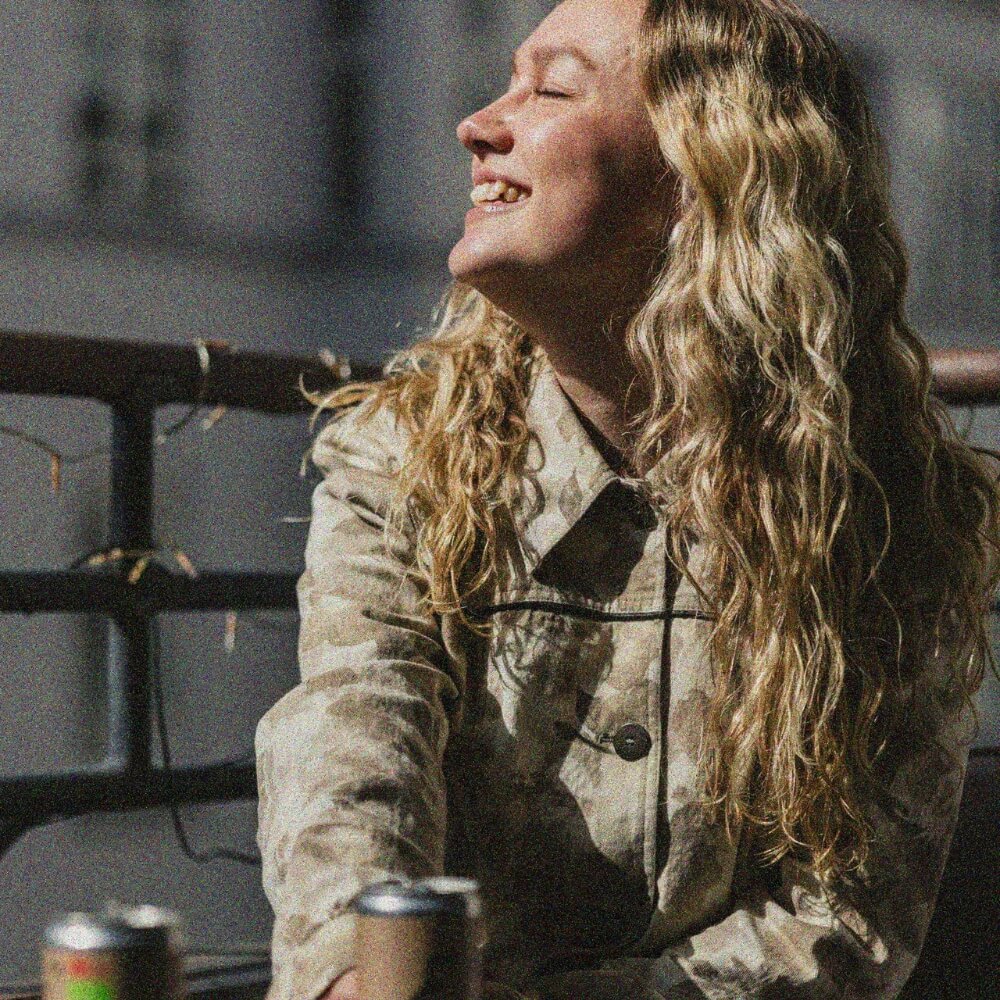 Woman sitting on a balcony in the sun